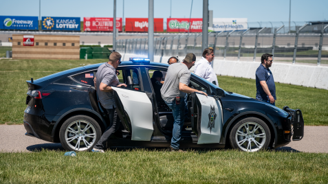 men getting into electric police vehicle for test drive
