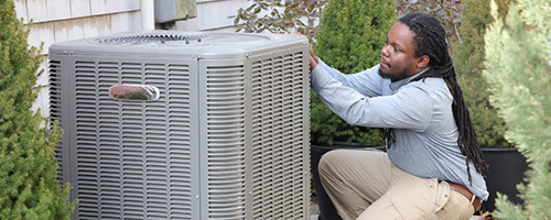 HVAC contractor inspects AC unit